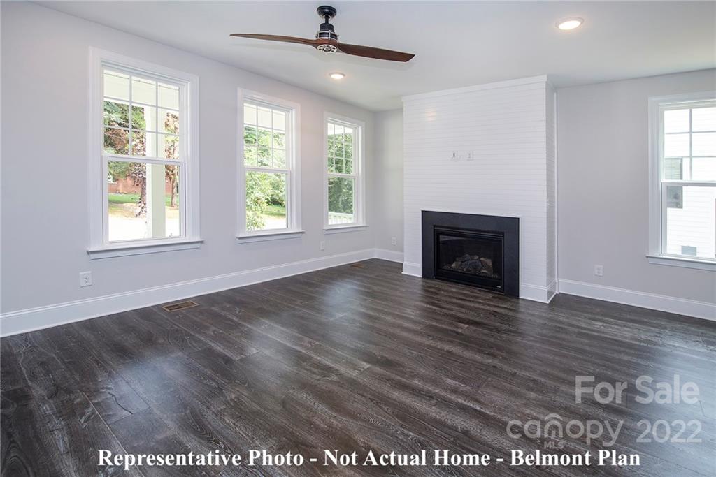 1362 High Shoals Road Lincolnton, NC 28092 - Photo 6 of 18 a view of an empty room with wooden floor fireplace and a window