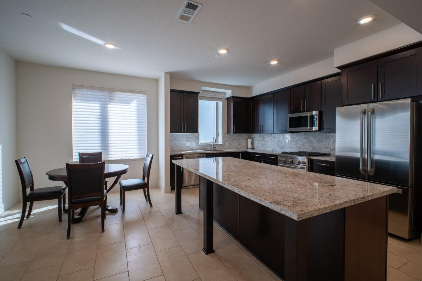 708 Eppleton Lane, Unit 204 Foster City, CA 94404 - Photo 19 of 46 a kitchen with a stove a sink a microwave and a refrigerator