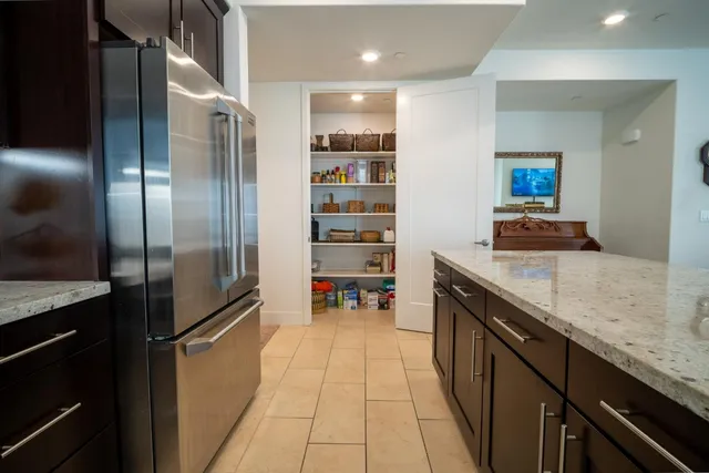 a kitchen with stainless steel appliances granite countertop a refrigerator and a sink