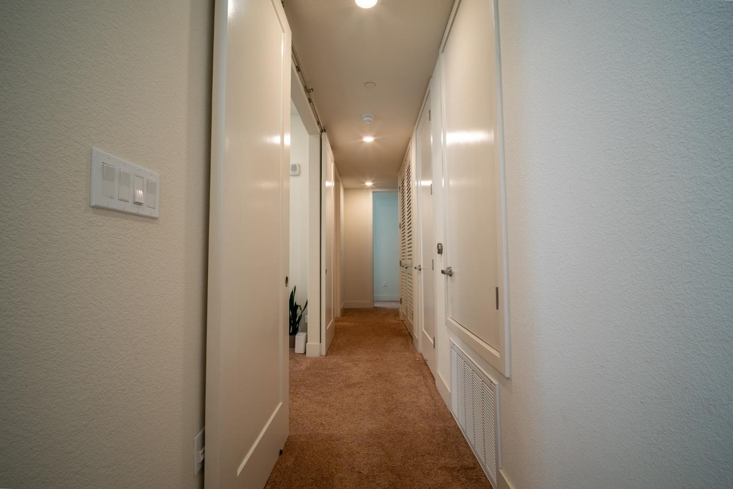 708 Eppleton Lane, Unit 204 Foster City, CA 94404 - Photo 27 of 46 a view of a hallway with wooden shelves