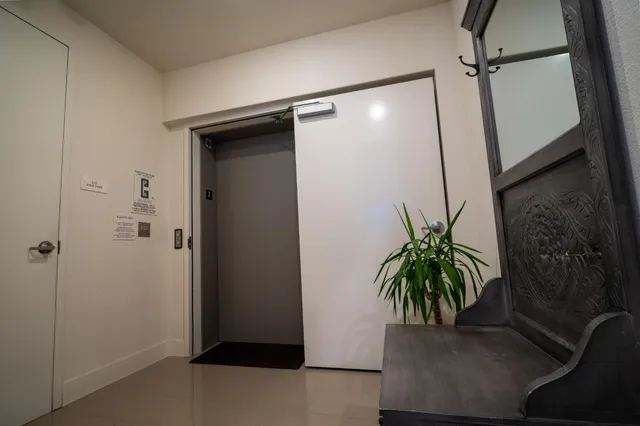 a potted plant in a bathroom next to a glass door