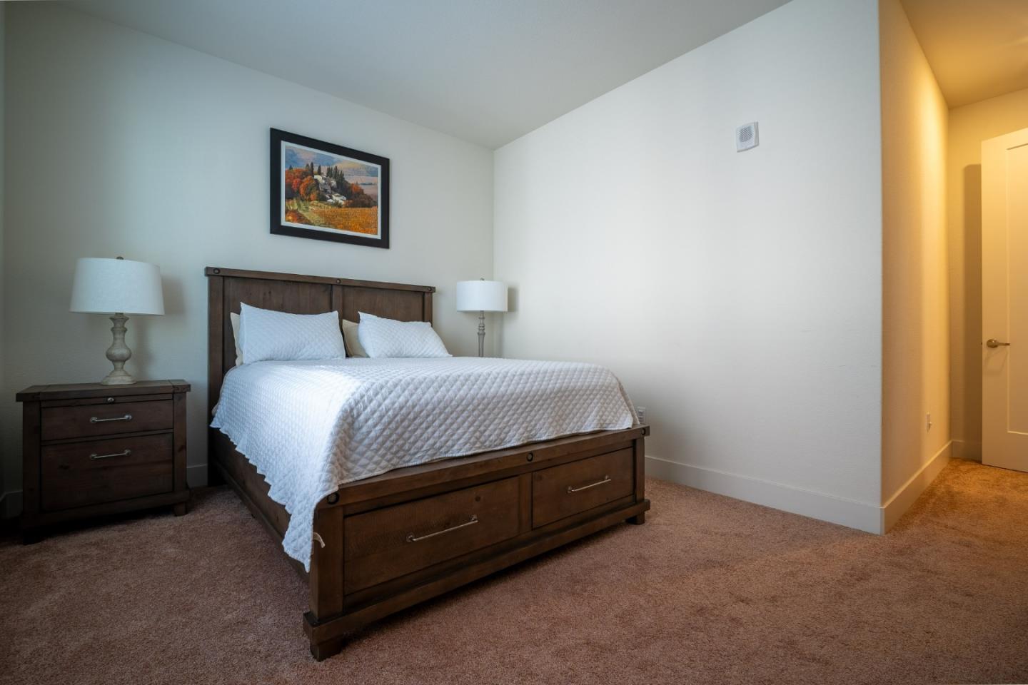 708 Eppleton Lane, Unit 204 Foster City, CA 94404 - Photo 31 of 46 a spacious bedroom with a bed and a painting on the wall