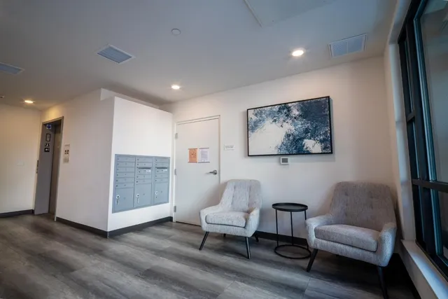 a living room with furniture and a painting