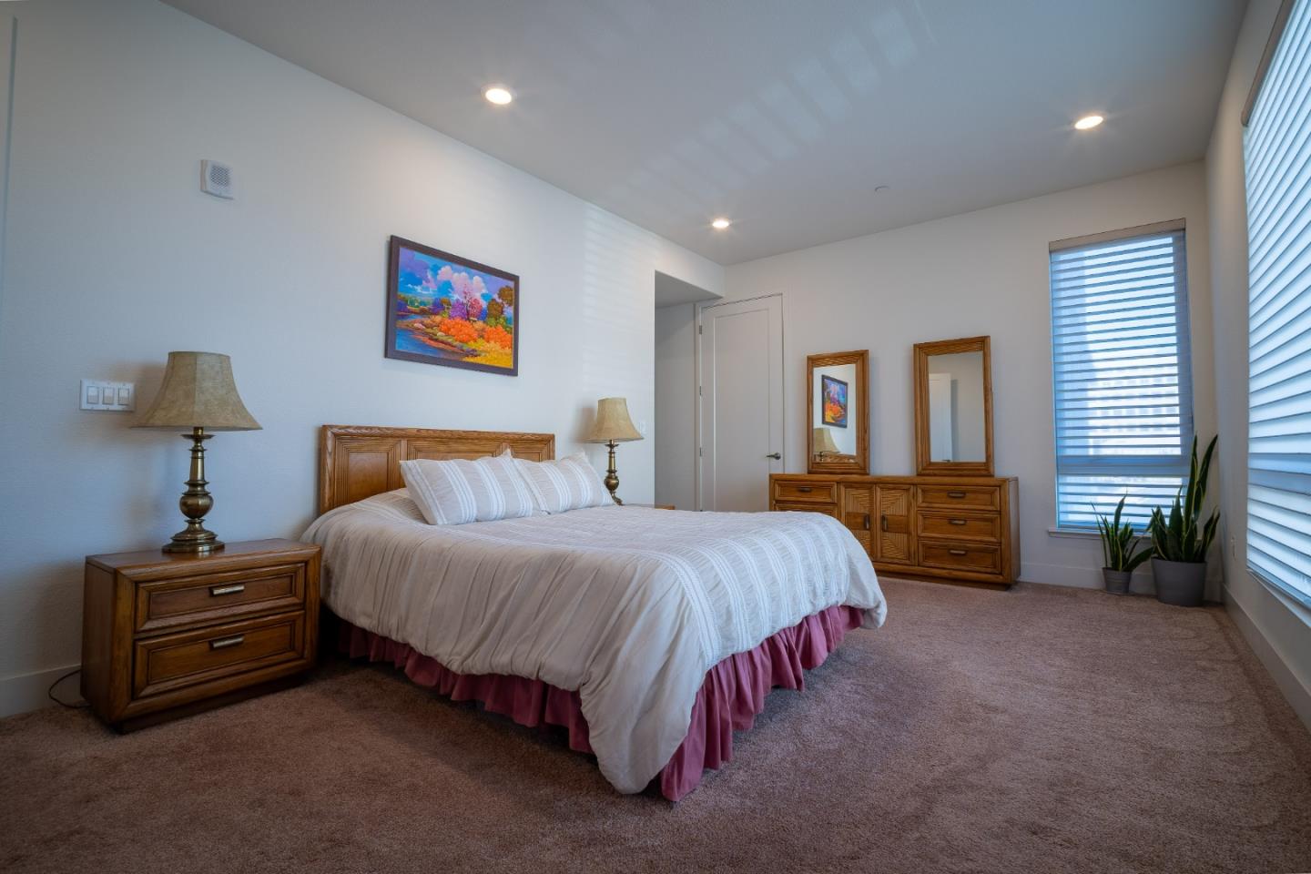 708 Eppleton Lane, Unit 204 Foster City, CA 94404 - Photo 9 of 46 a spacious bedroom with a bed and a chandelier