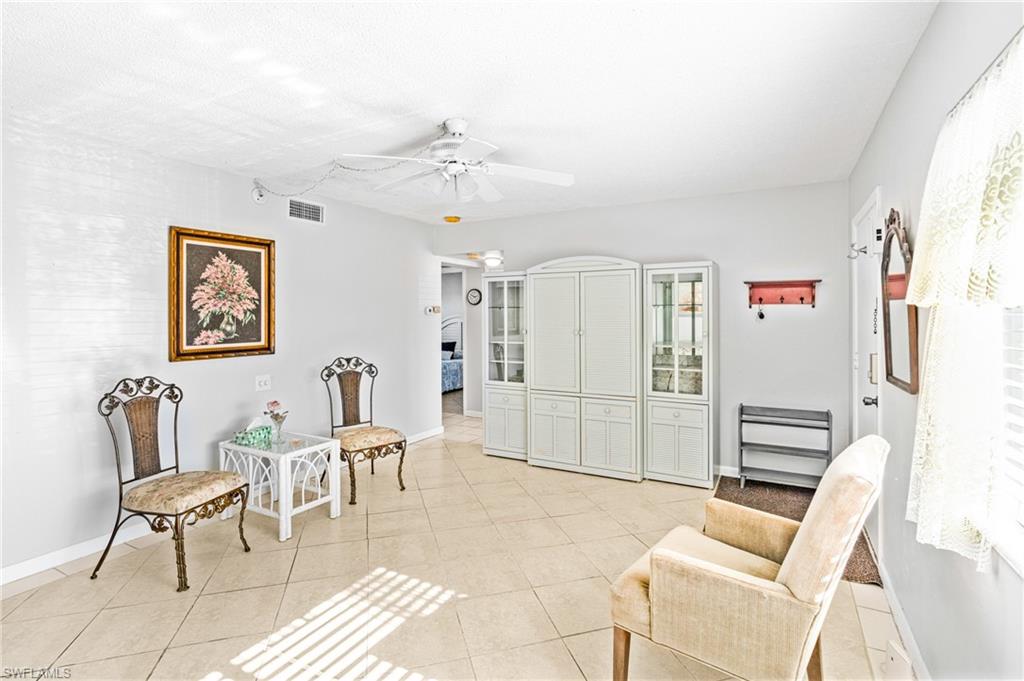 345 Joel Boulevard, Unit 110 Lehigh Acres, FL 33936 - Photo 11 of 47 a living room with furniture a window and a table