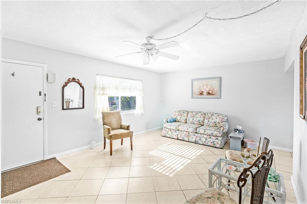 345 Joel Boulevard, Unit 110 Lehigh Acres, FL 33936 - Photo 12 of 47 a living room with furniture and a window