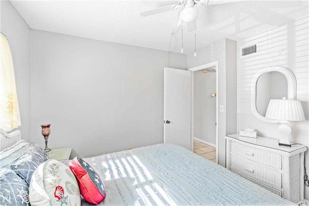 345 Joel Boulevard, Unit 110 Lehigh Acres, FL 33936 - Photo 16 of 47 a bedroom with a bed and a dresser