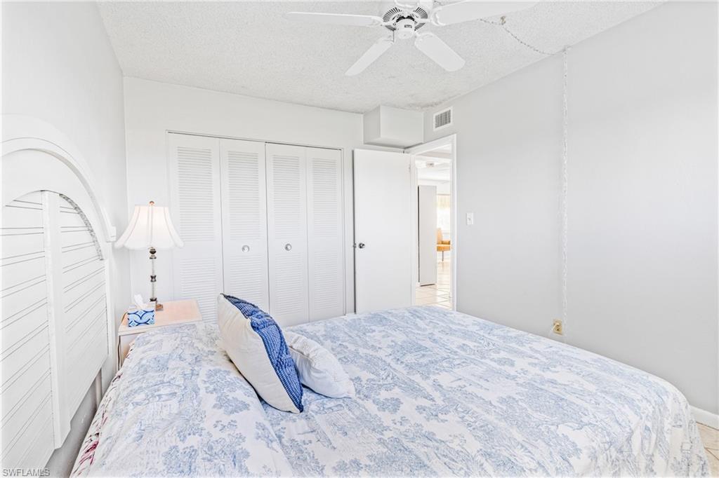 345 Joel Boulevard, Unit 110 Lehigh Acres, FL 33936 - Photo 19 of 47 a bedroom with a bed and a chandelier