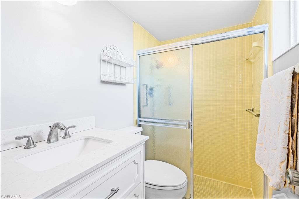 345 Joel Boulevard, Unit 110 Lehigh Acres, FL 33936 - Photo 20 of 47 a bathroom with a granite countertop sink toilet and shower