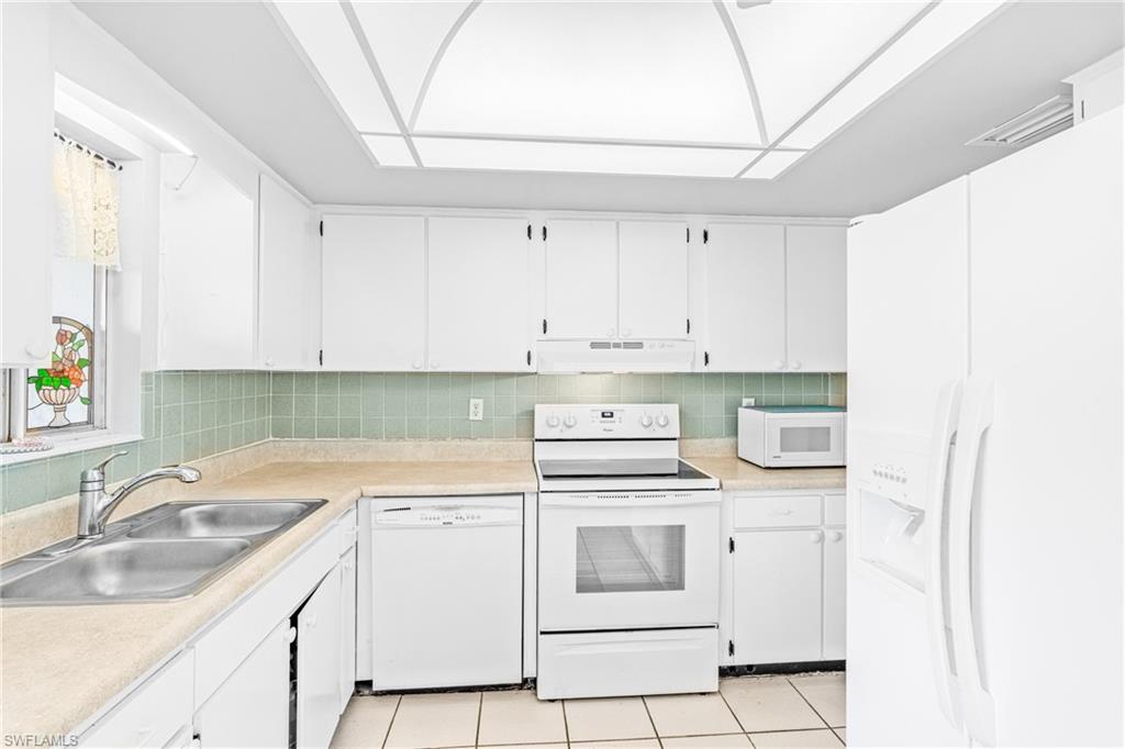 345 Joel Boulevard, Unit 110 Lehigh Acres, FL 33936 - Photo 24 of 47 a view of white cabinets and sink