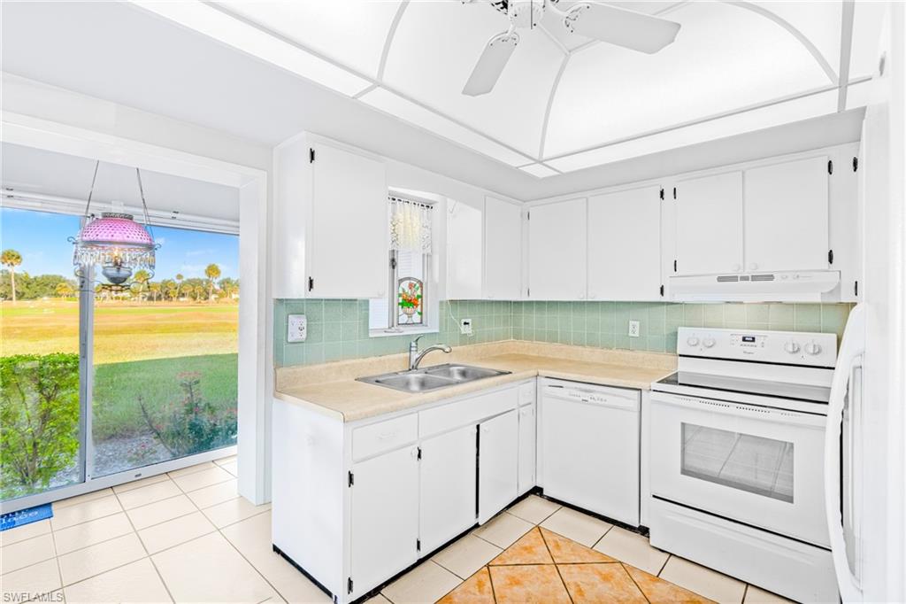 345 Joel Boulevard, Unit 110 Lehigh Acres, FL 33936 - Photo 25 of 47 a kitchen with a stove sink and cabinets