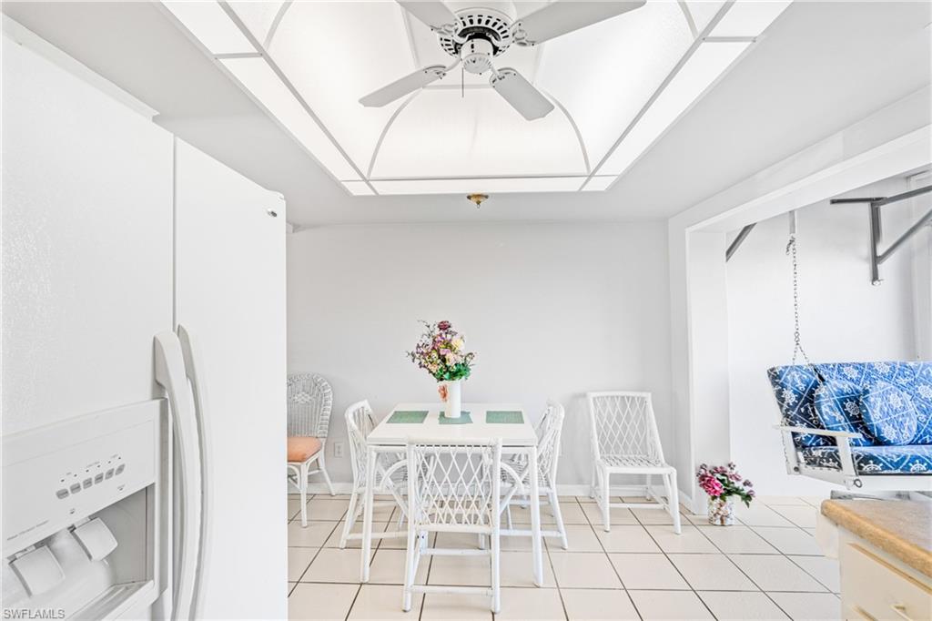 345 Joel Boulevard, Unit 110 Lehigh Acres, FL 33936 - Photo 26 of 47 a living room with furniture and a chandelier