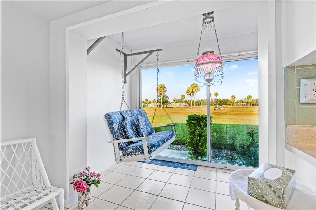 345 Joel Boulevard, Unit 110 Lehigh Acres, FL 33936 - Photo 27 of 47 a dining room with glass top table and chairs