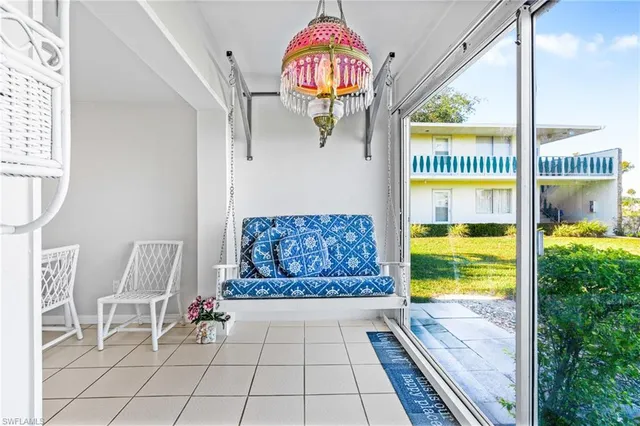 a living room with furniture and a floor to ceiling window