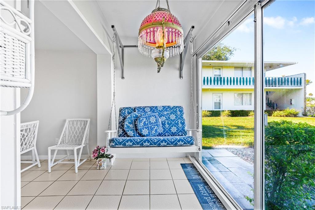 345 Joel Boulevard, Unit 110 Lehigh Acres, FL 33936 - Photo 28 of 47 a living room with furniture and a floor to ceiling window