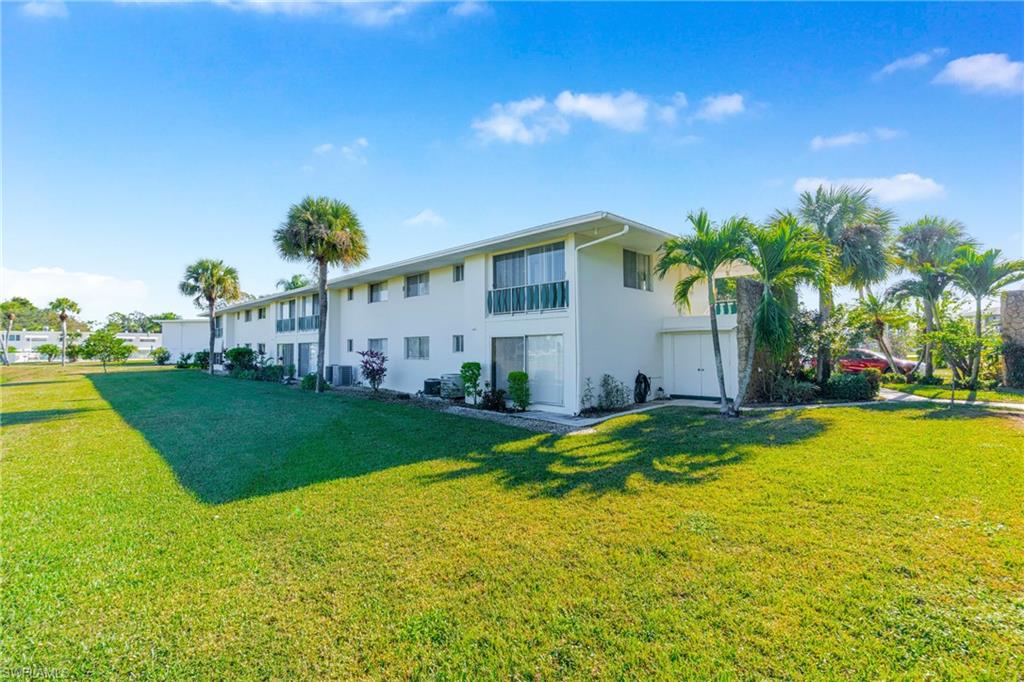345 Joel Boulevard, Unit 110 Lehigh Acres, FL 33936 - Photo 30 of 47 a view of a house with pool and garden