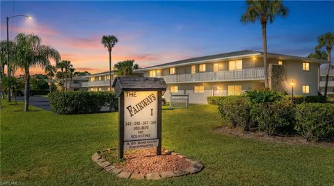 a front view of a house with a garden and yard