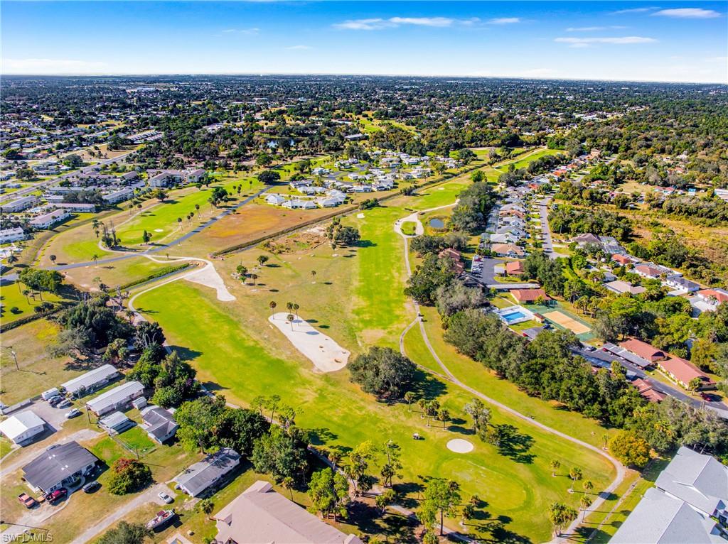 345 Joel Boulevard, Unit 110 Lehigh Acres, FL 33936 - Photo 36 of 47 an aerial view of residential houses with outdoor space
