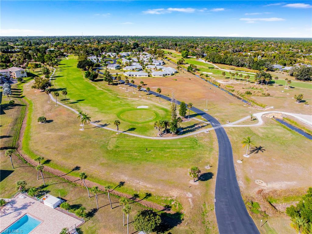 345 Joel Boulevard, Unit 110 Lehigh Acres, FL 33936 - Photo 7 of 47 an aerial view of residential houses with outdoor space