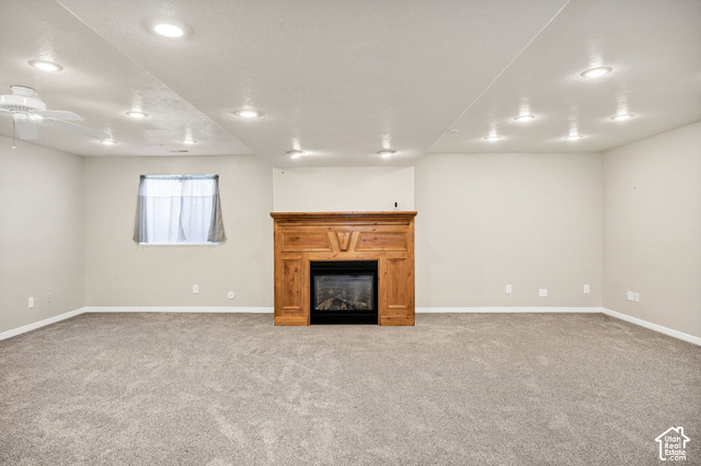 1143 East Mountain Road Logan, UT 84321 - Photo 24 of 64 Spacious room with recessed lighting, plush carpeting, a ceiling fan, and a built-in fireplace with a wood mantel