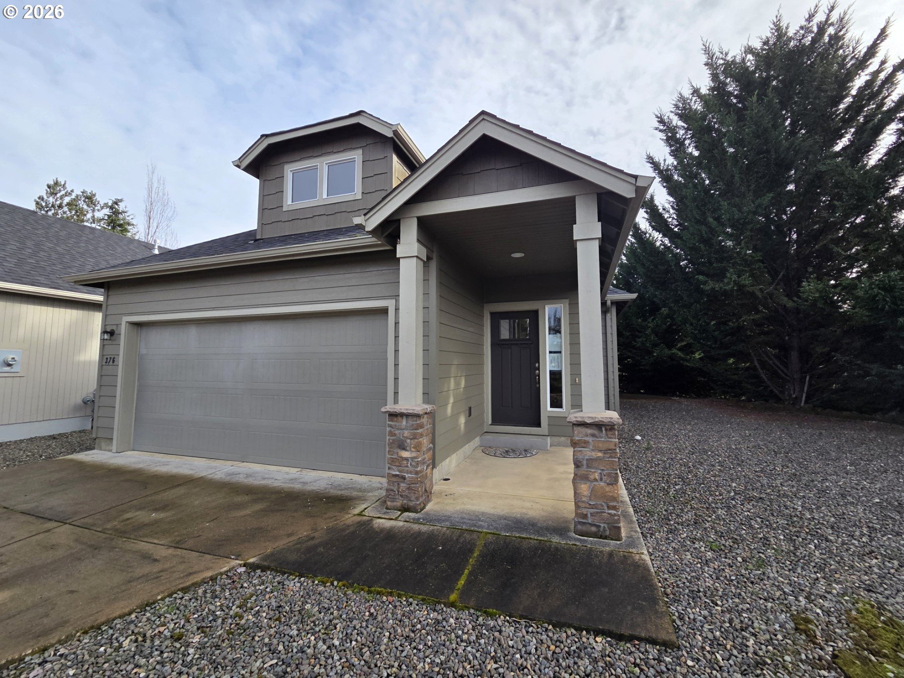 376 Bentgrass Court Sutherlin, OR 97479 - Photo 1 of 17 a front view of a house with a yard and garage