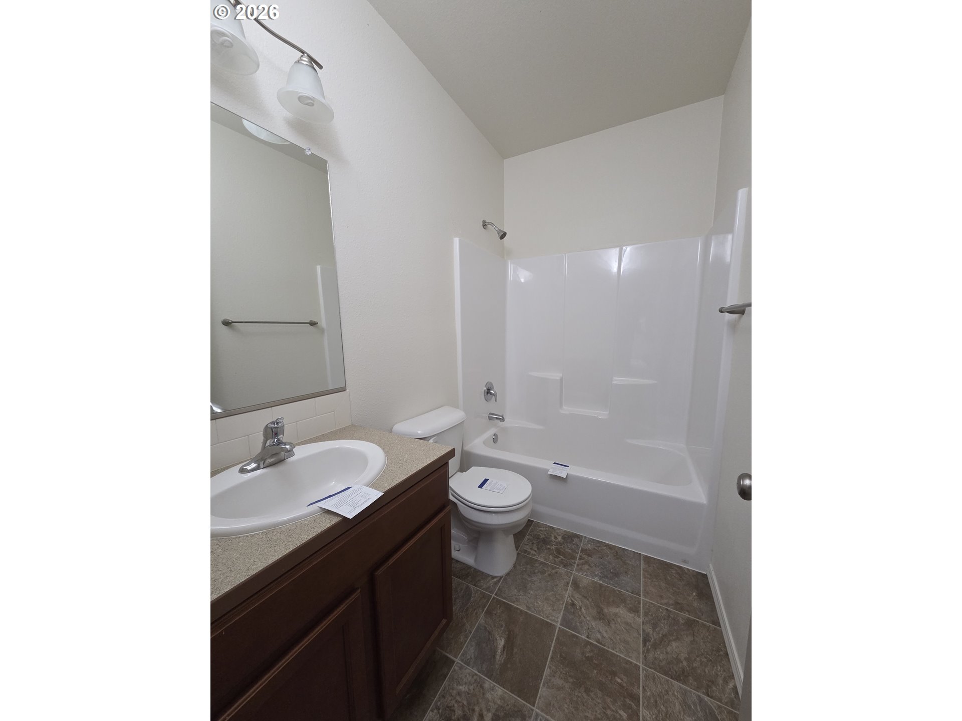 376 Bentgrass Court Sutherlin, OR 97479 - Photo 11 of 17 a bathroom with a granite countertop sink toilet a large mirror and shower