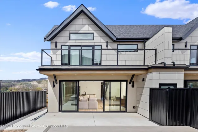 a bedroom with a bed and a large window with outer view