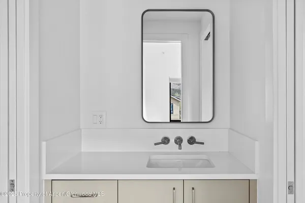 a bedroom with a large bed and a large window