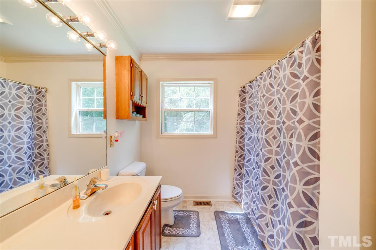 190 Landmark Road Willow Spring, NC 27592 - Photo 13 of 25 a bathroom with a sink and a mirror