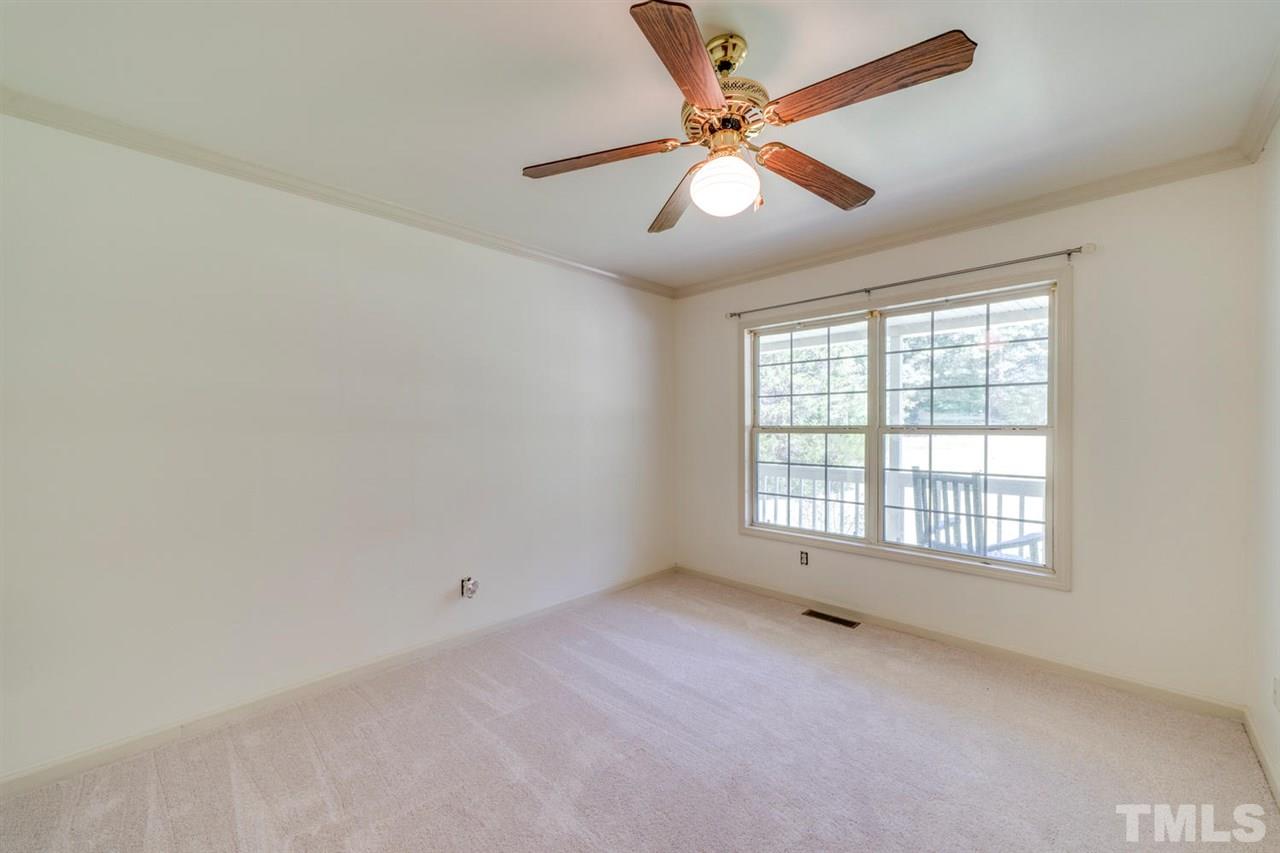 190 Landmark Road Willow Spring, NC 27592 - Photo 14 of 25 an empty room with chandelier fan and windows
