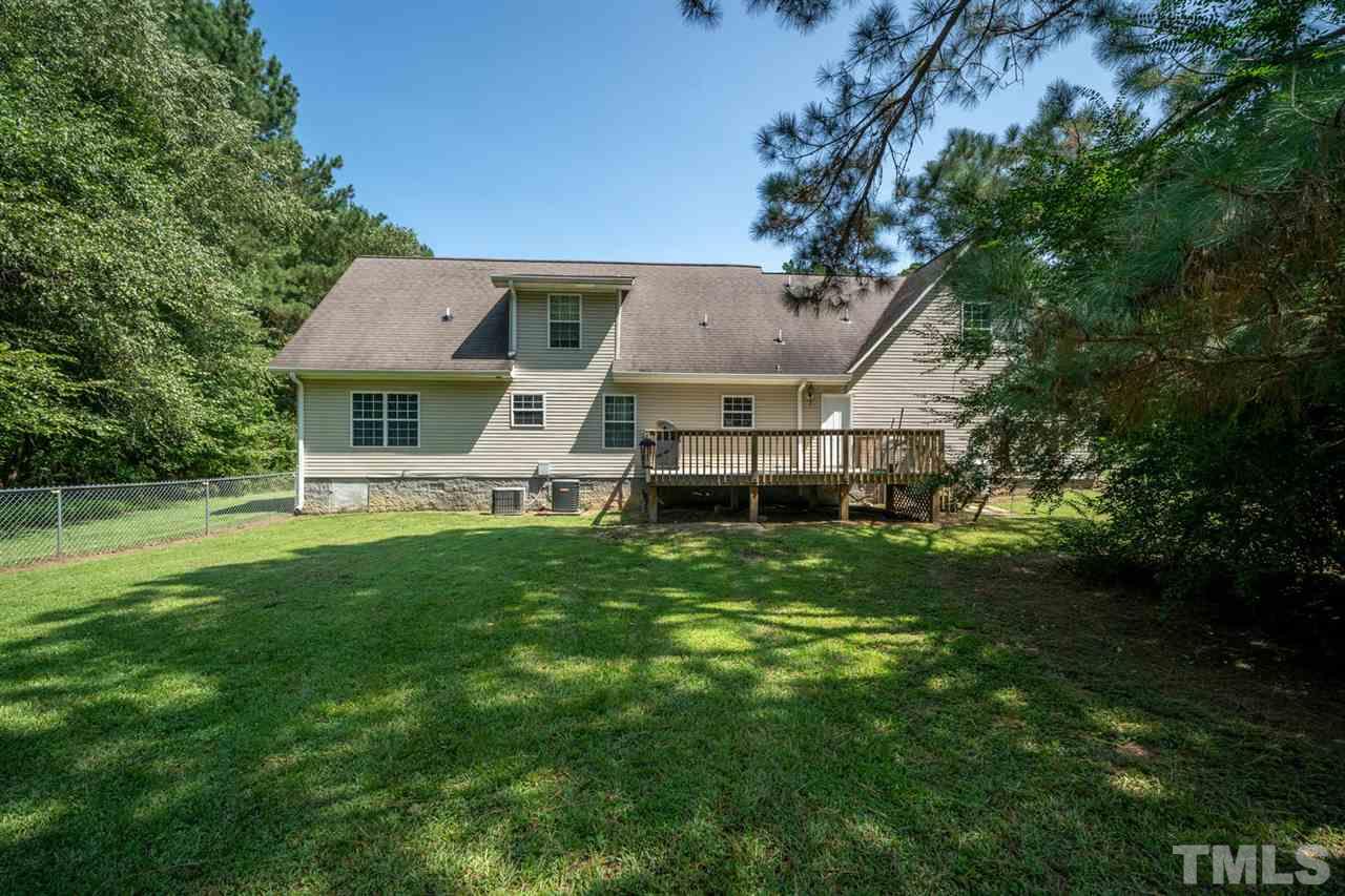 190 Landmark Road Willow Spring, NC 27592 - Photo 21 of 25 a front view of a house with a garden and trees