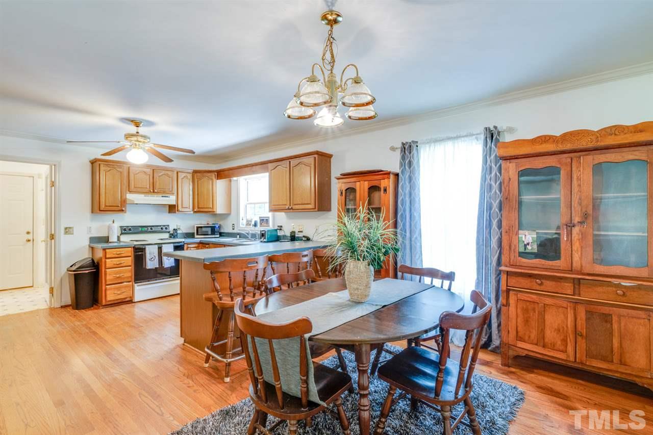 190 Landmark Road Willow Spring, NC 27592 - Photo 6 of 25 a view of a dining room with furniture window and wooden floor