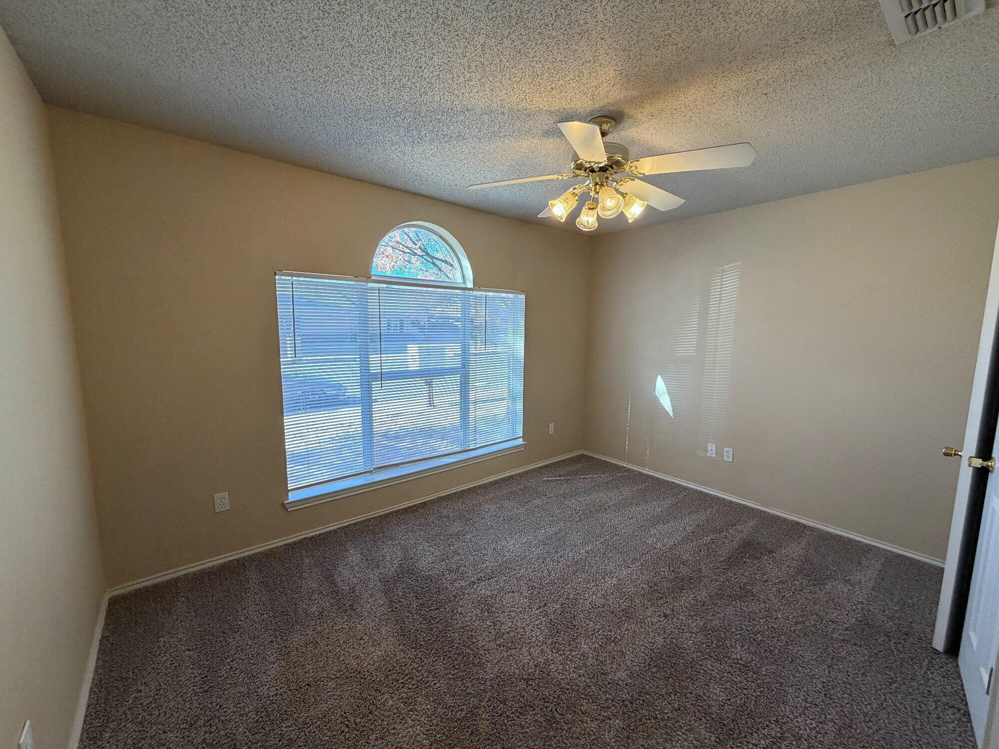 9713 Joliet Avenue Lubbock, TX 79423 - Photo 11 of 18 an empty room with a fan & a window