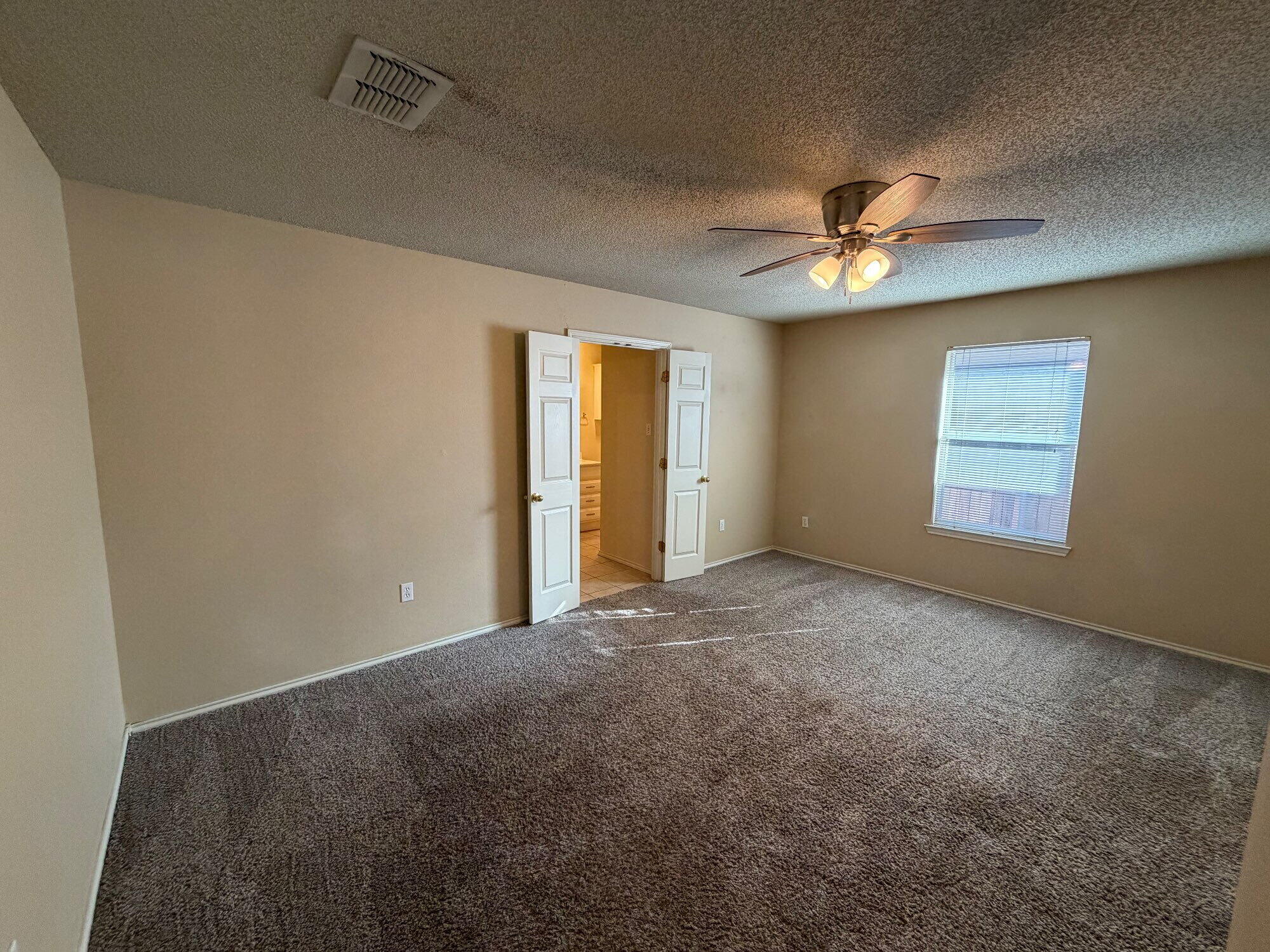 9713 Joliet Avenue Lubbock, TX 79423 - Photo 12 of 18 a view of an empty room with a window
