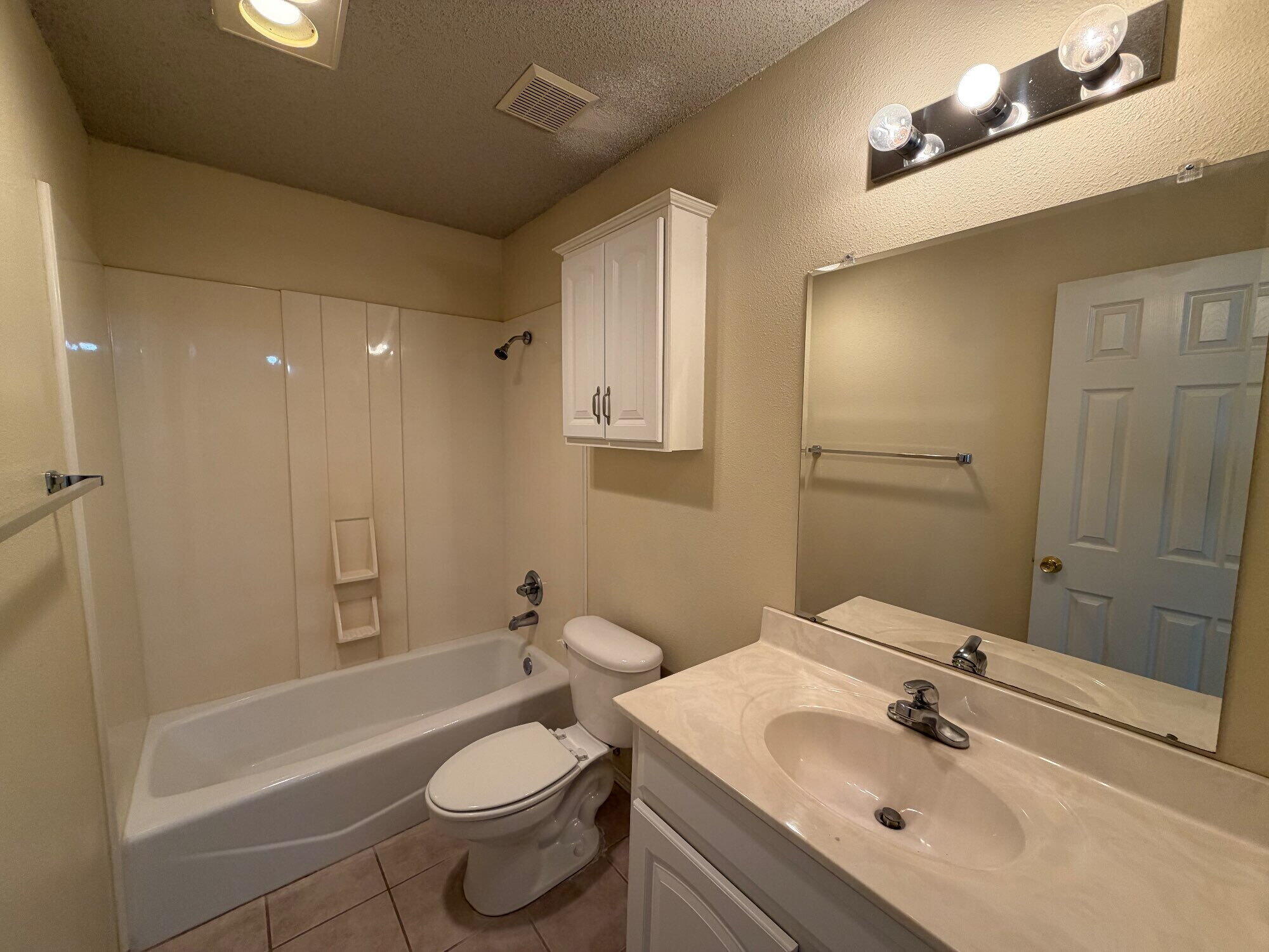 9713 Joliet Avenue Lubbock, TX 79423 - Photo 13 of 18 a bathroom with a sink toilet and shower