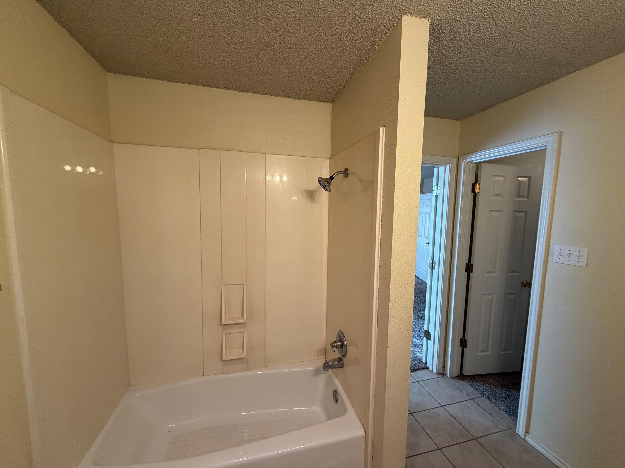9713 Joliet Avenue Lubbock, TX 79423 - Photo 16 of 18 a bathroom with a bathtub