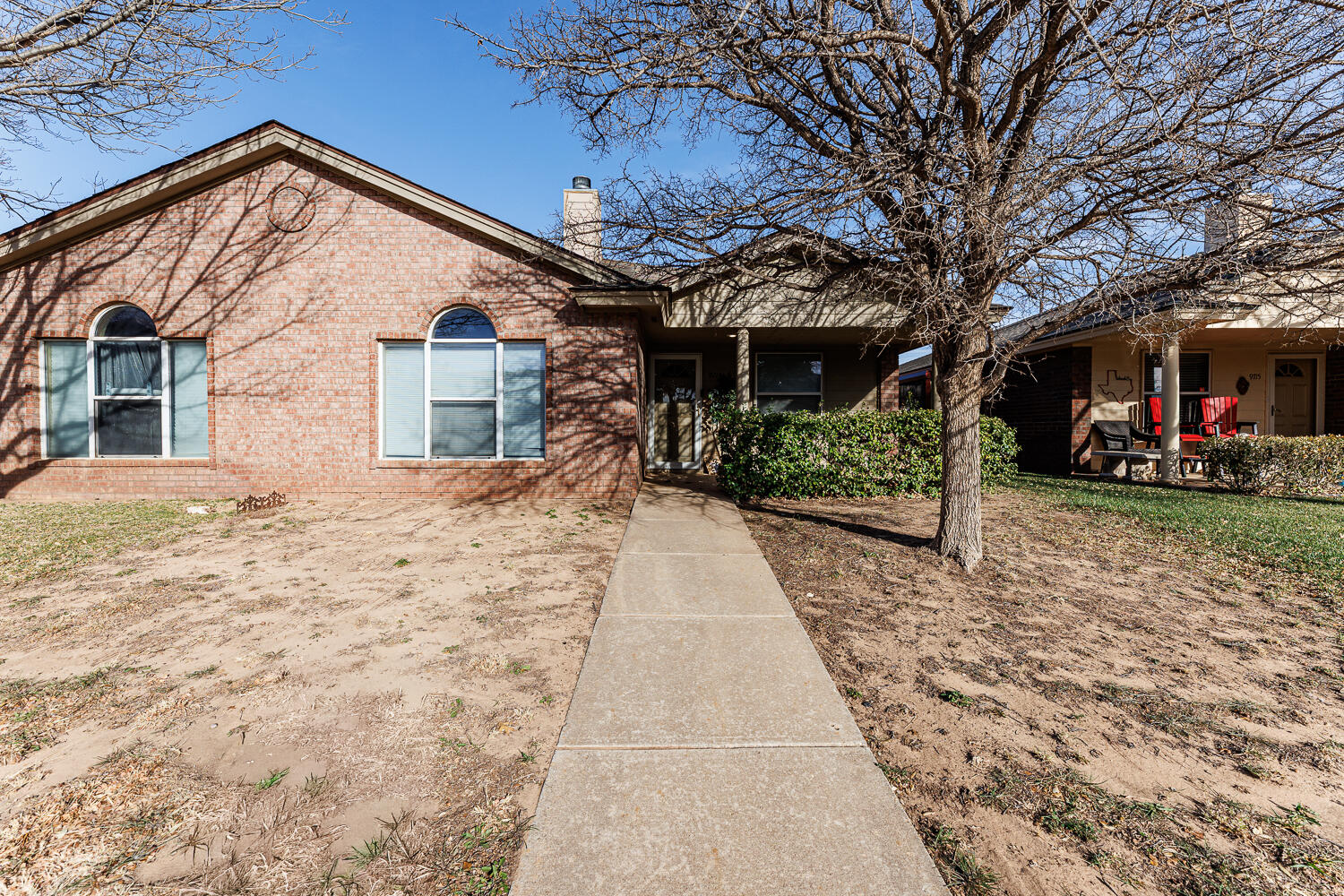 9713 Joliet Avenue Lubbock, TX 79423 - Photo 3 of 18 a front view of a house with a yard and potted plants