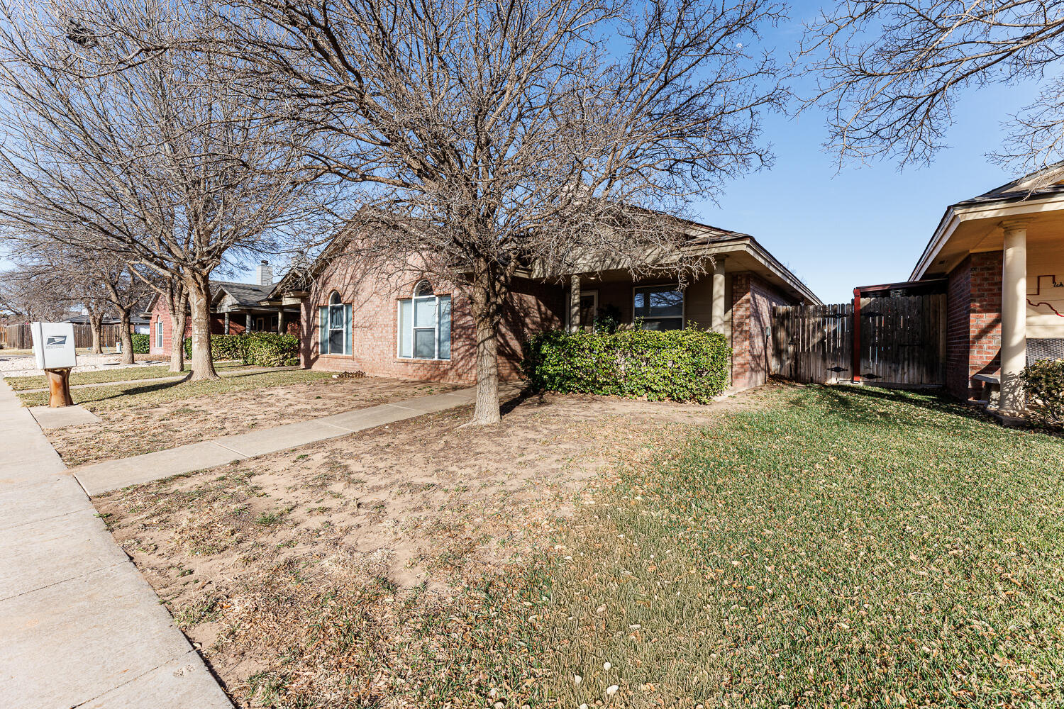 9713 Joliet Avenue Lubbock, TX 79423 - Photo 4 of 18 a front view of a house with a yard