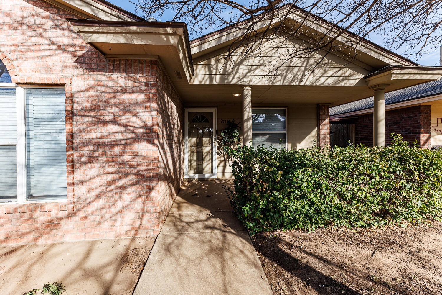 9713 Joliet Avenue Lubbock, TX 79423 - Photo 5 of 18 a front view of a house with garden