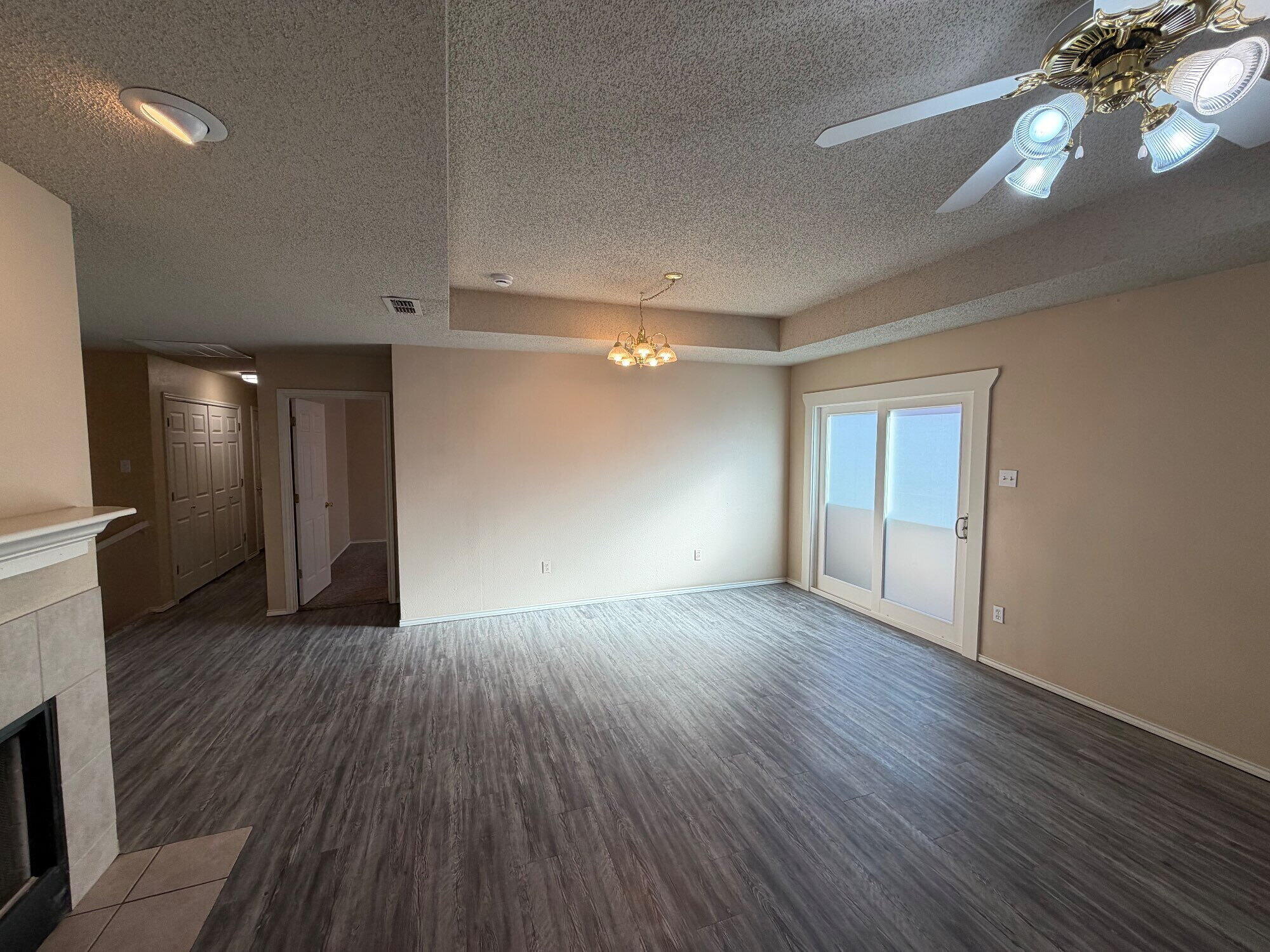 9713 Joliet Avenue Lubbock, TX 79423 - Photo 9 of 18 a view of an empty room with wooden floor and a window