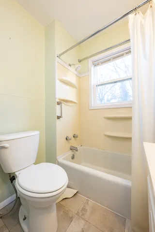 a bathroom with a toilet a sink and a bathtub
