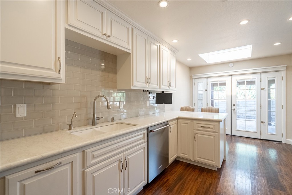 5965 Maybrook Circle Riverside, CA 92506 - Photo 12 of 25 a kitchen with a sink cabinets stainless steel appliances and wooden floor