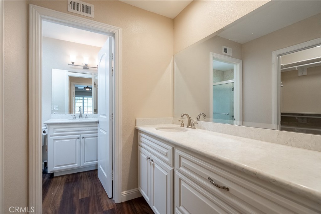 5965 Maybrook Circle Riverside, CA 92506 - Photo 20 of 25 a en suite bathroom with a sink and mirror