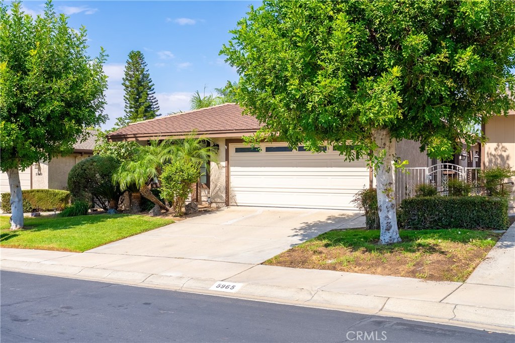 5965 Maybrook Circle Riverside, CA 92506 - Photo 2 of 25 a front view of a house with a yard and trees
