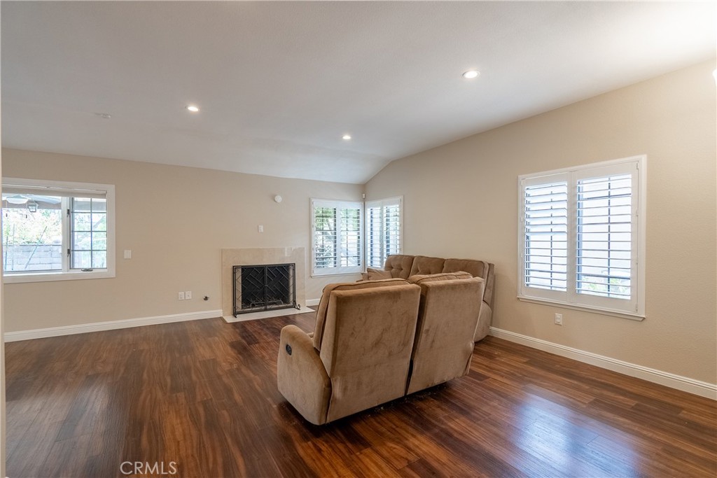 5965 Maybrook Circle Riverside, CA 92506 - Photo 5 of 25 a living room with furniture a fireplace and a flat screen tv