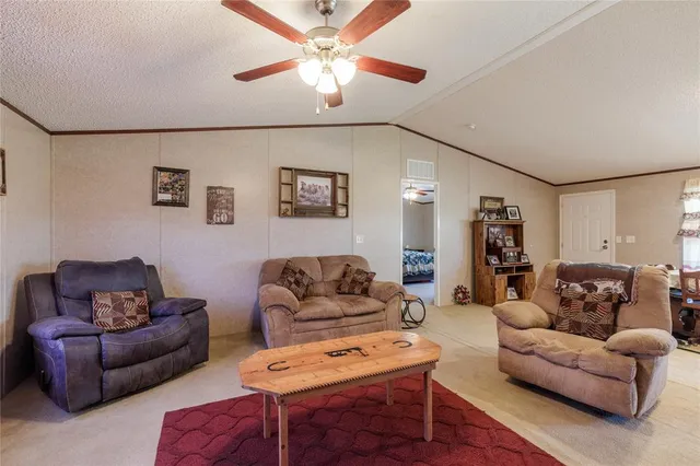 a living room with furniture a couch and a chandelier