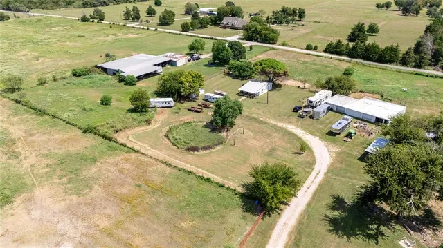 an aerial view of a house with a garden and lake view