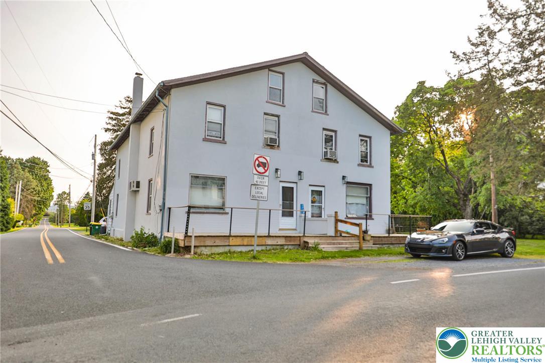 a view of a car parked in front of a house