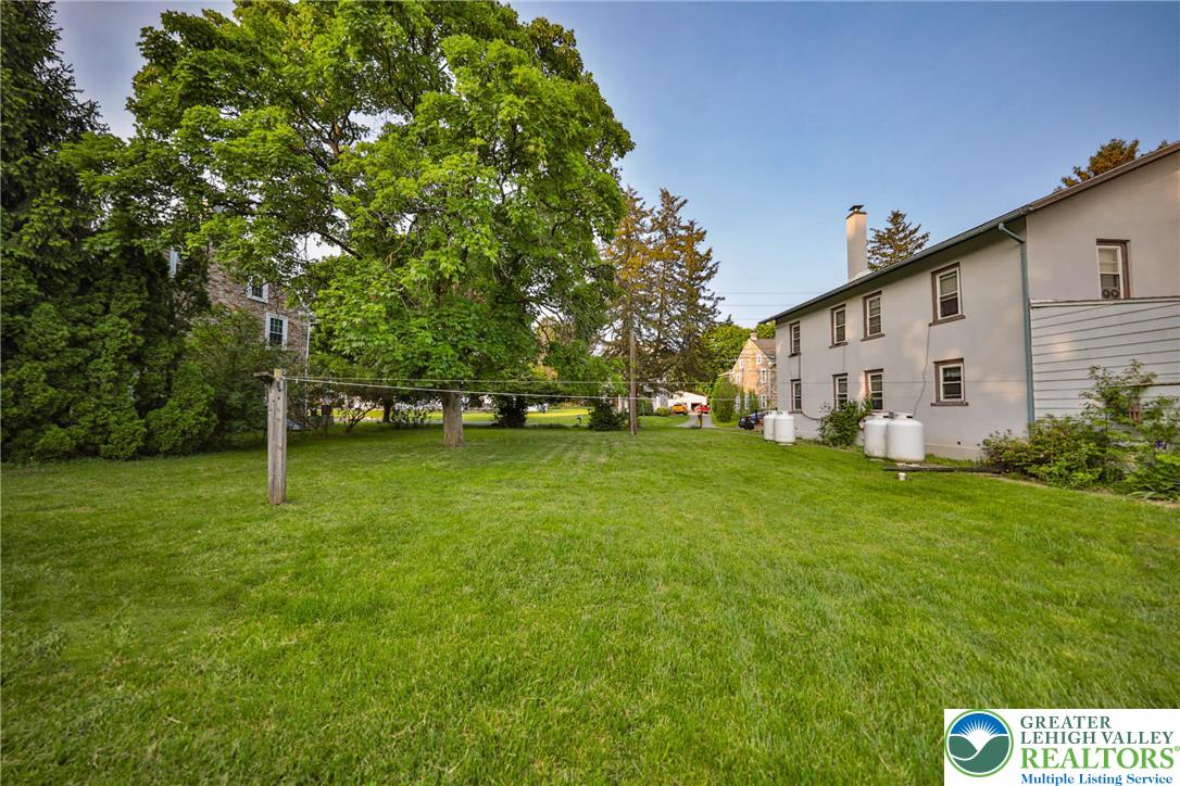 1770 Weilers Road Lower Macungie Township, PA 18011 - Photo 16 of 29 a view of a white house with a big yard and large trees