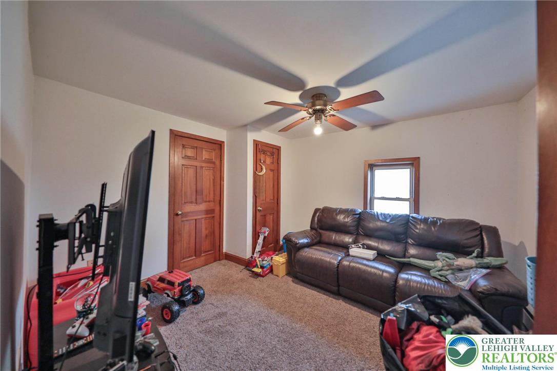 1770 Weilers Road Lower Macungie Township, PA 18011 - Photo 21 of 29 a living room with furniture a ceiling fan and a window